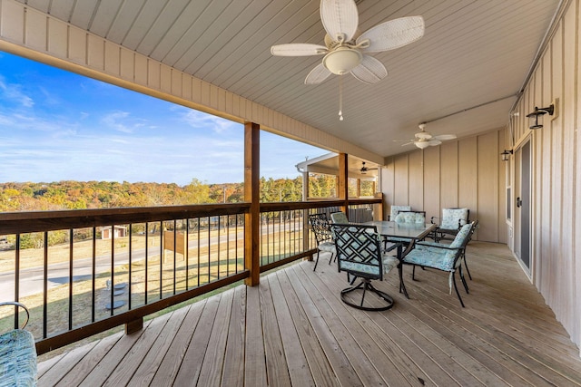 wooden deck featuring a ceiling fan and outdoor dining space