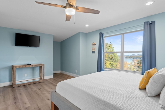 bedroom featuring recessed lighting, ceiling fan, wood finished floors, and baseboards