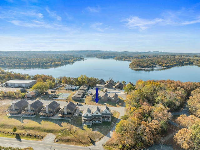 aerial view with a water view and a forest view