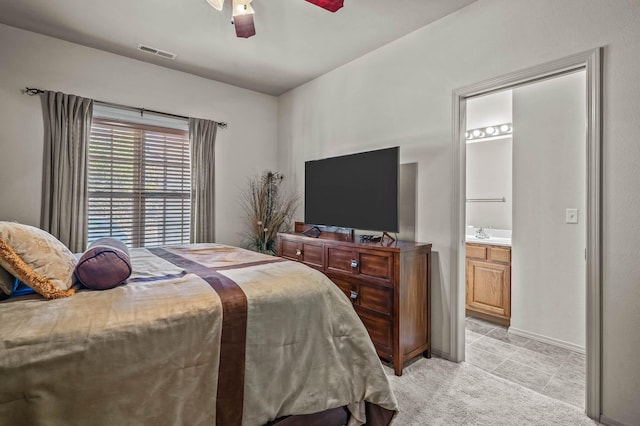 bedroom featuring ensuite bathroom, ceiling fan, and sink