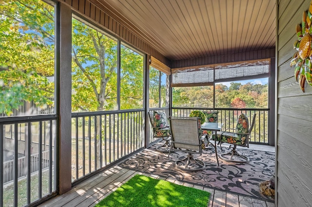 unfurnished sunroom with wood ceiling