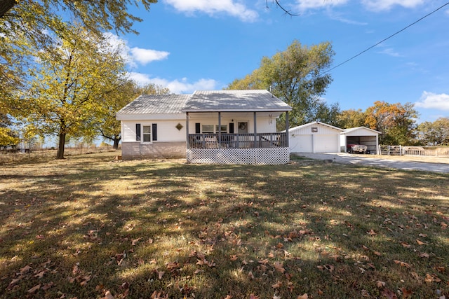 exterior space featuring a garage, a front lawn, a carport, an outdoor structure, and a deck