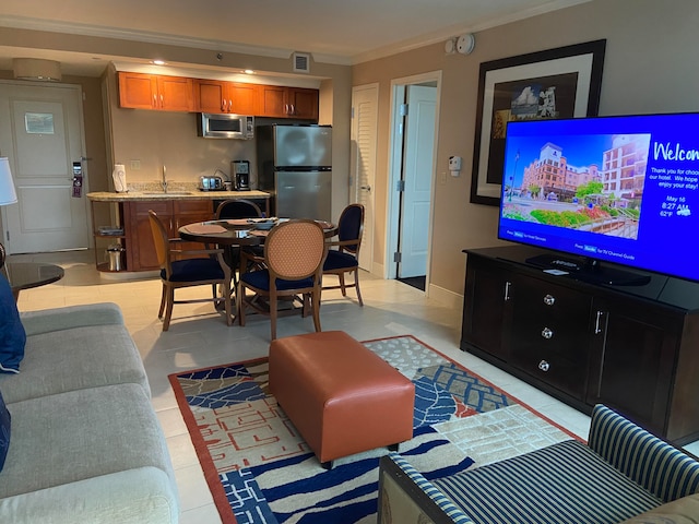 living room with crown molding and sink