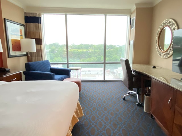 bedroom featuring ornamental molding and carpet flooring