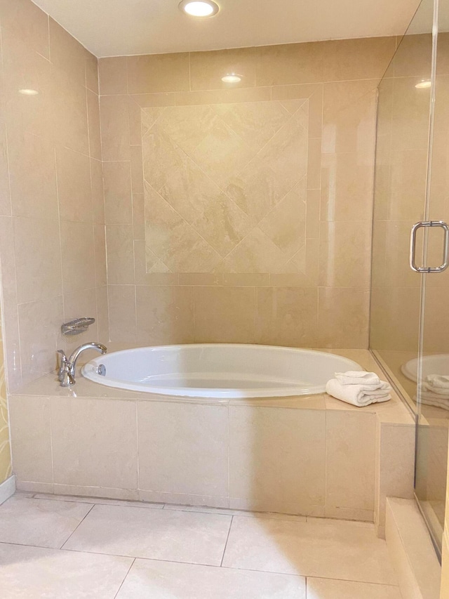 bathroom featuring tile walls, plus walk in shower, and tile patterned flooring