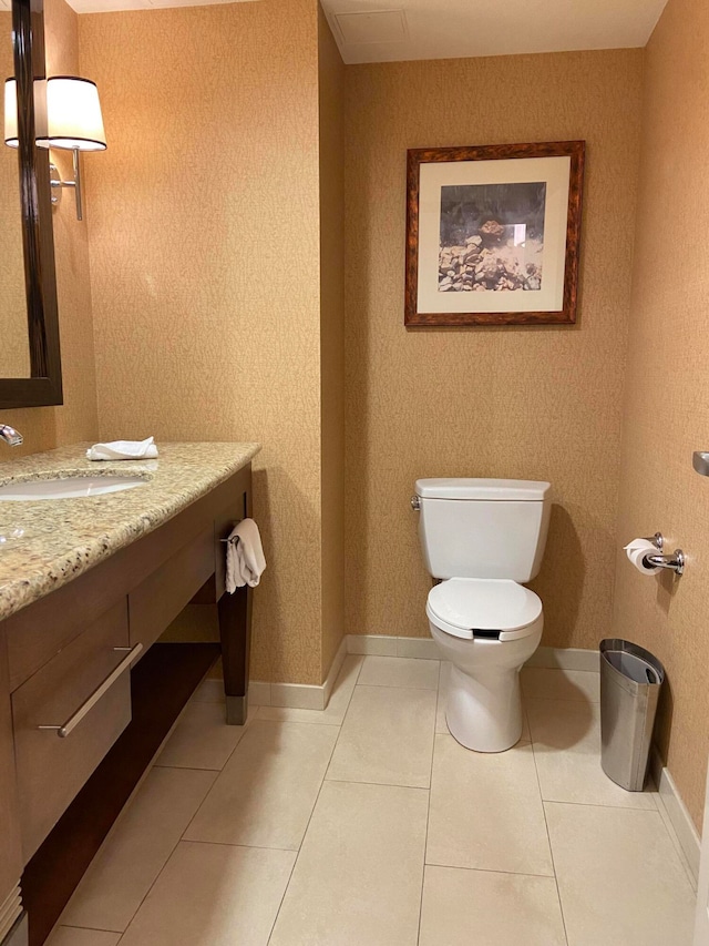 bathroom with vanity, toilet, and tile patterned flooring