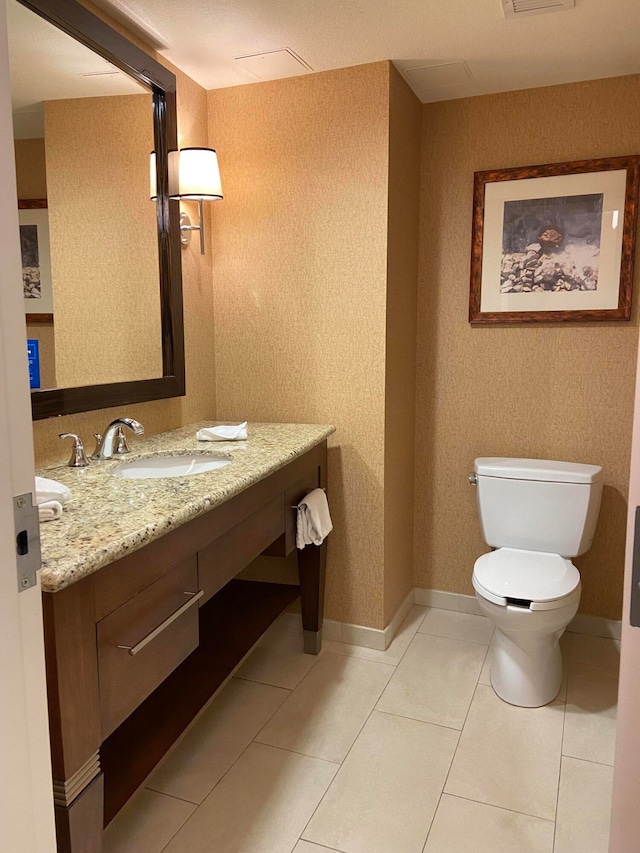 bathroom with vanity, toilet, and tile patterned floors