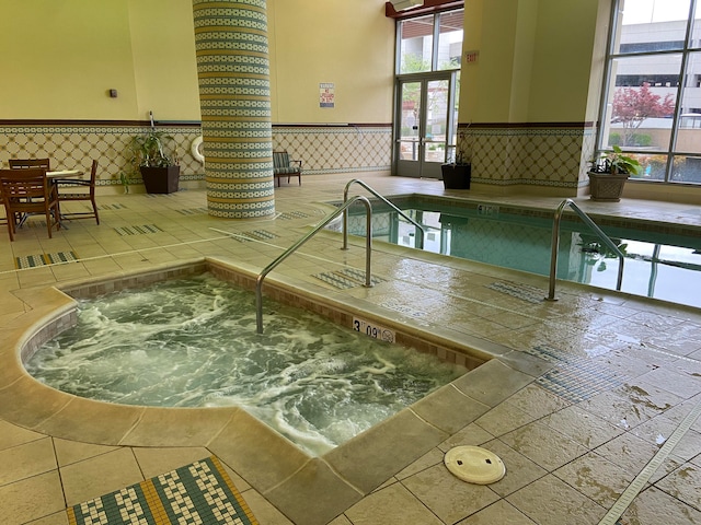 view of swimming pool with an indoor in ground hot tub