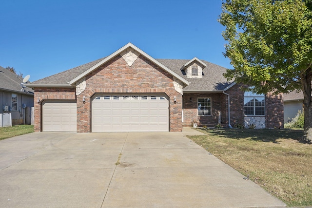 view of front of property with a front yard and a garage