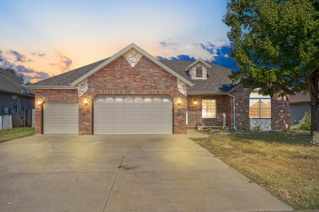 view of front of property featuring a yard and a garage