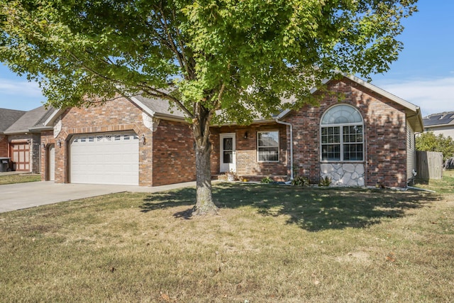 view of front of property with a front yard and a garage