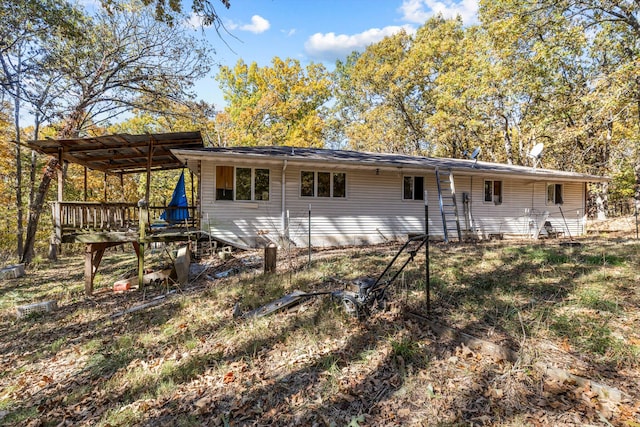 back of property featuring a wooden deck