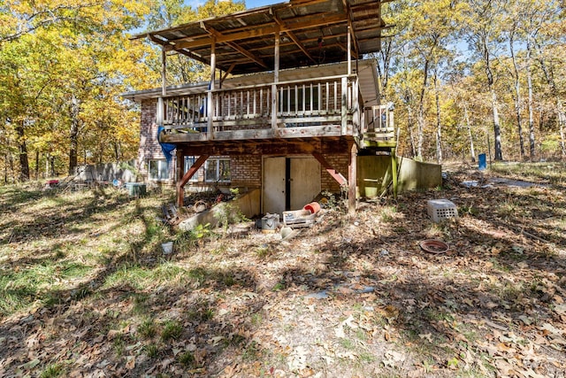 back of house with a wooden deck