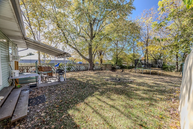 view of yard featuring a patio area and a trampoline