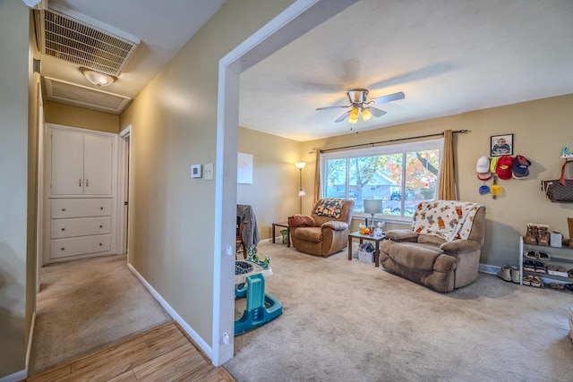 living room with ceiling fan and hardwood / wood-style flooring