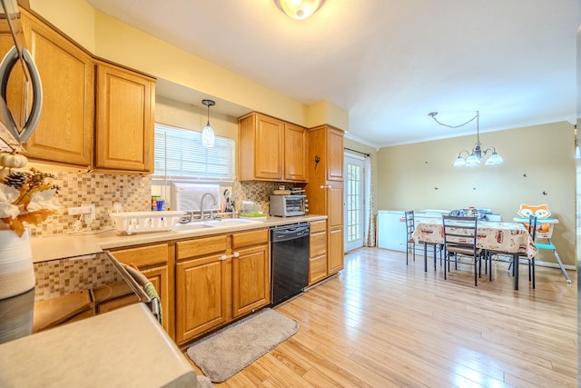 kitchen featuring light hardwood / wood-style floors, a notable chandelier, dishwasher, and hanging light fixtures