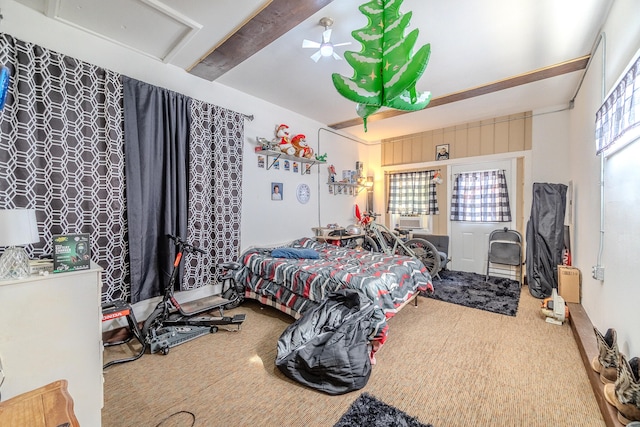 bedroom featuring carpet flooring, beamed ceiling, and cooling unit