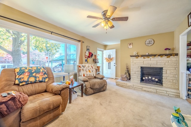 living room with carpet, a fireplace, and ceiling fan