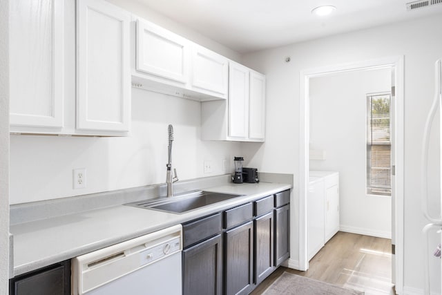 kitchen featuring white cabinetry, dishwasher, sink, and light wood-type flooring