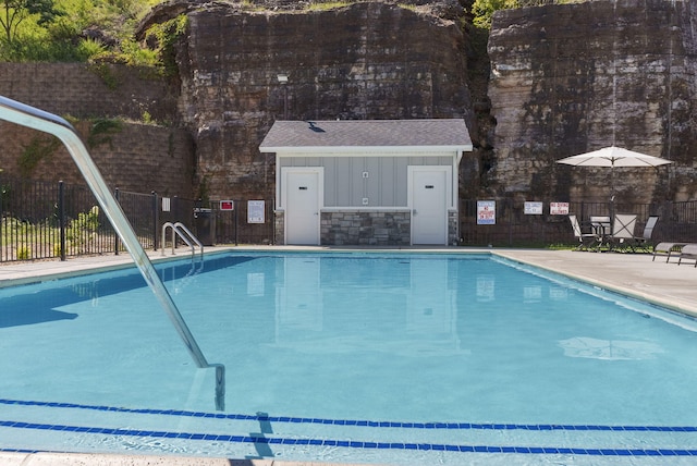 view of pool with an outbuilding