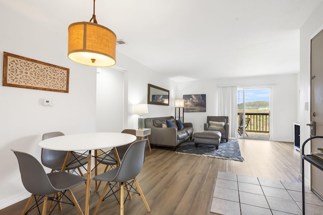 dining space with hardwood / wood-style floors