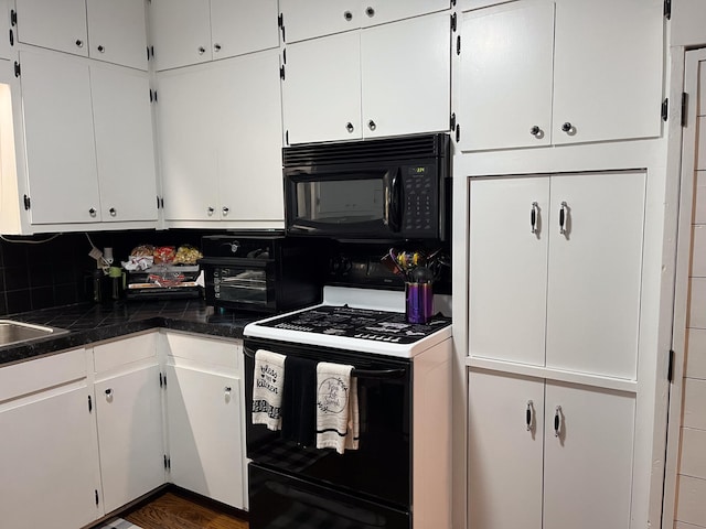 kitchen featuring black appliances, white cabinetry, and decorative backsplash