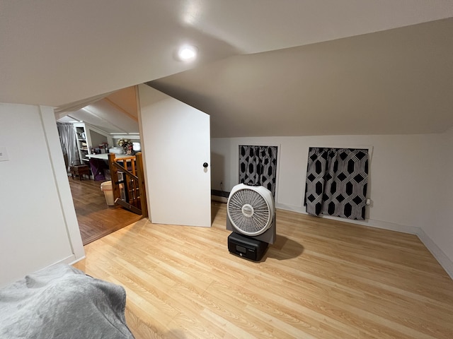 bonus room featuring vaulted ceiling and light wood-type flooring