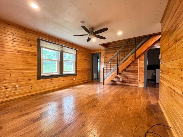 1025 Woodland Ave, West Plains, MO 65775 - unfurnished living room with wood walls, stairway, ceiling fan, wood finished floors, and recessed lighting