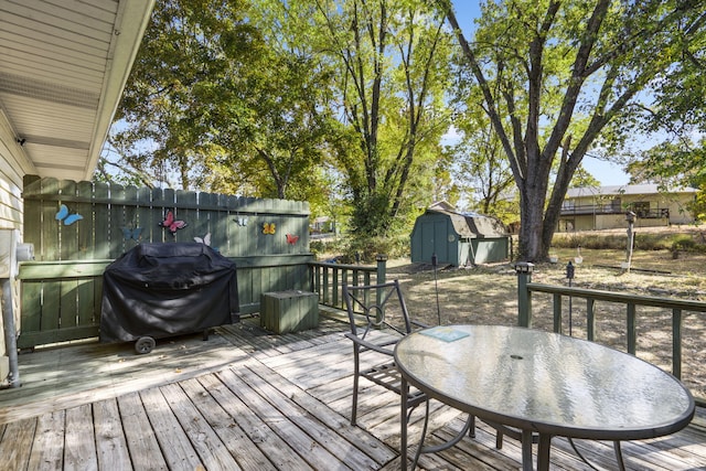 deck featuring area for grilling and a storage shed