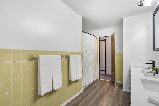 bathroom featuring vanity, tile walls, and hardwood / wood-style floors