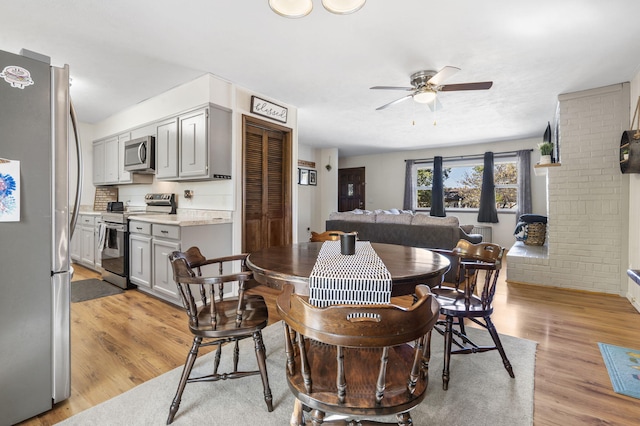 dining space featuring light hardwood / wood-style flooring and ceiling fan