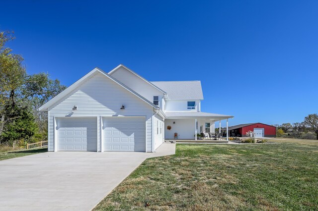 236 N Dade 147, Greenfield, MO 65661 - view of home's exterior featuring concrete driveway, covered porch, a garage, and a yard