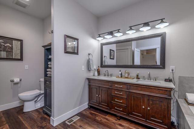 236 N Dade 147, Greenfield, MO 65661 - bathroom with double vanity, toilet, wood finished floors, and baseboards