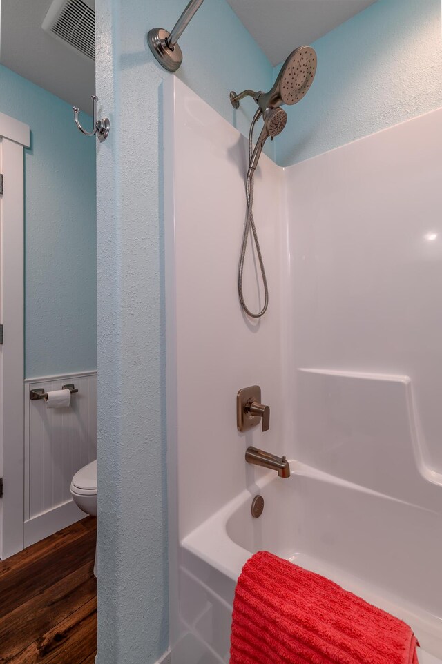 236 N Dade 147, Greenfield, MO 65661 - bathroom with bathing tub / shower combination, toilet, and wood finished floors