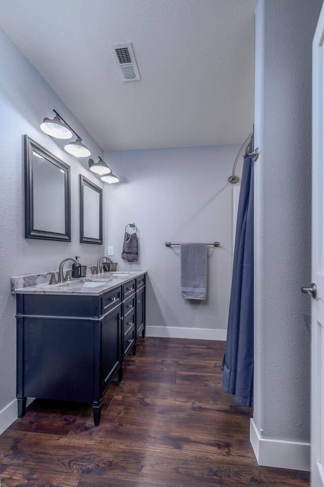 236 N Dade 147, Greenfield, MO 65661 - full bath featuring baseboards, double vanity, wood finished floors, and curtained shower