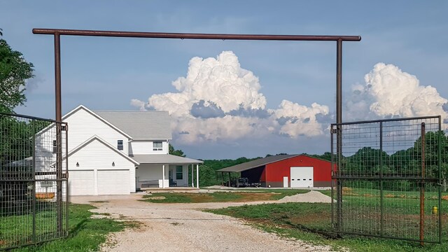 236 N Dade 147, Greenfield, MO 65661 - view of front of home featuring dirt driveway, a pole building, and an outdoor structure