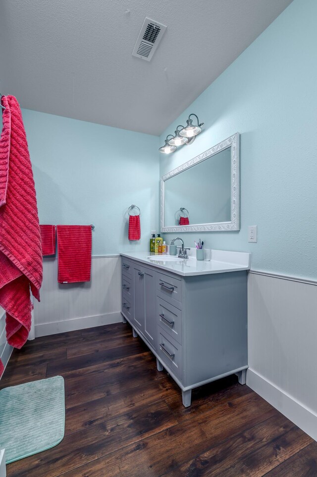 236 N Dade 147, Greenfield, MO 65661 - bathroom with vanity, wood finished floors, wainscoting, and baseboards