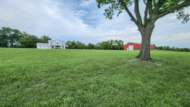 236 N Dade 147, Greenfield, MO 65661 - view of grassy yard featuring a detached garage, a pole building, and a view of rural / pastoral area