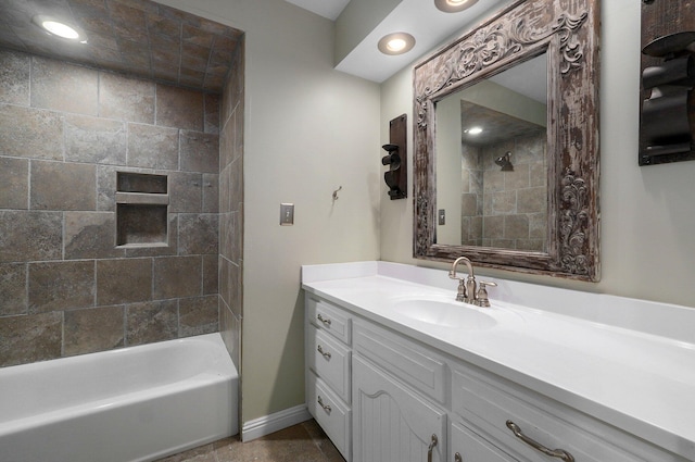 bathroom featuring vanity and tiled shower / bath