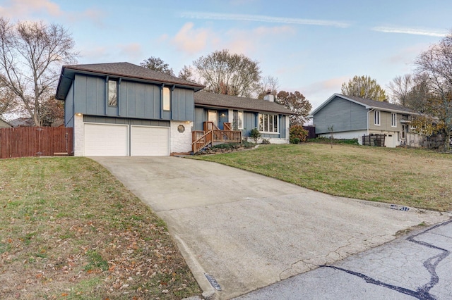 tri-level home with a front yard and a garage