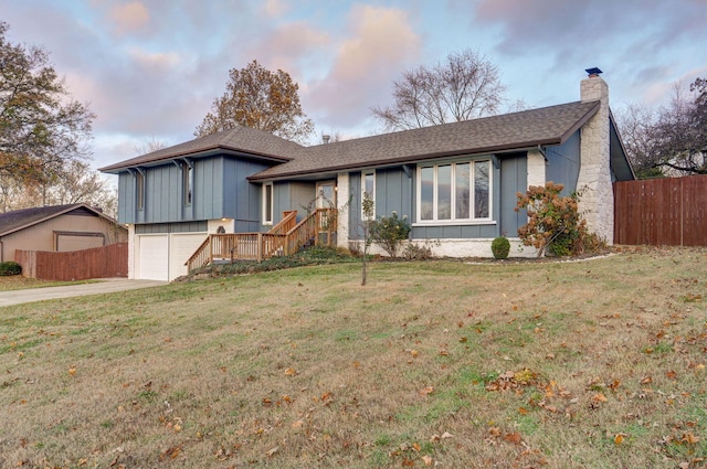 view of front of property with a front yard and a garage