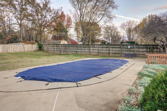 view of pool with a lawn and a patio area