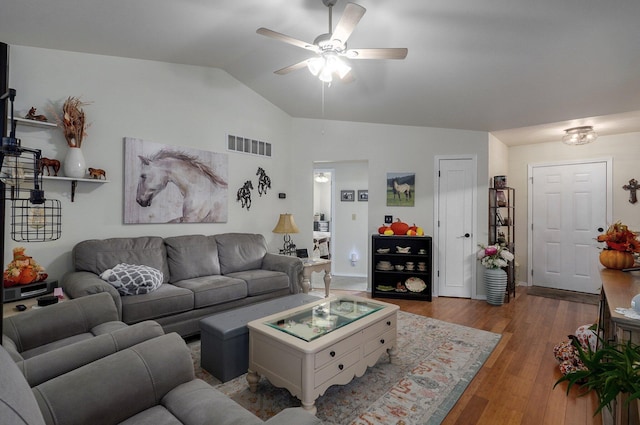 living room featuring ceiling fan, dark hardwood / wood-style flooring, and lofted ceiling