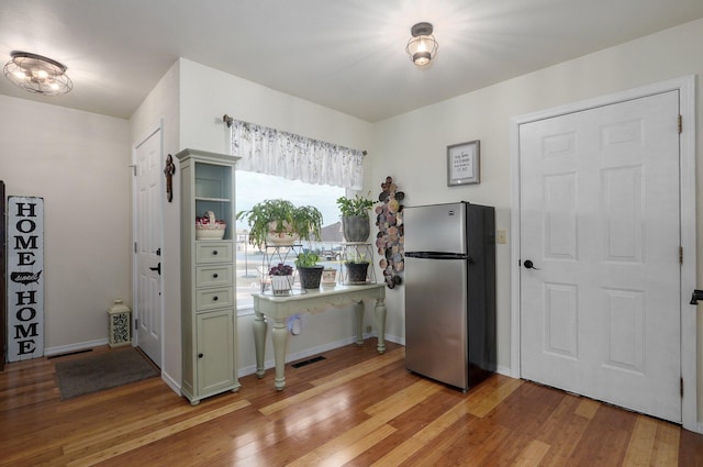 397 Micahs Xing, Reeds Spring, MO 65737 - kitchen featuring freestanding refrigerator, light wood finished floors, and baseboards