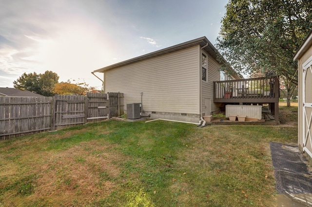 view of side of property featuring central AC unit, a deck, and a lawn