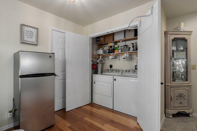 397 Micahs Xing, Reeds Spring, MO 65737 - laundry area with washer and clothes dryer and wood finished floors