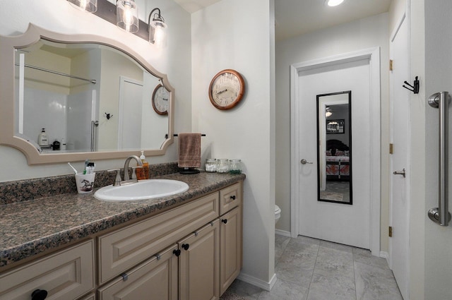 bathroom with vanity, toilet, and walk in shower