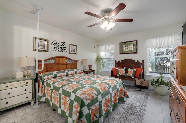 bedroom with ceiling fan and light tile patterned floors