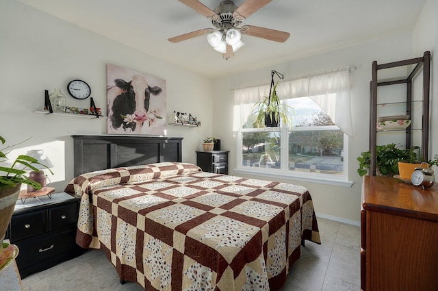 tiled bedroom featuring ceiling fan