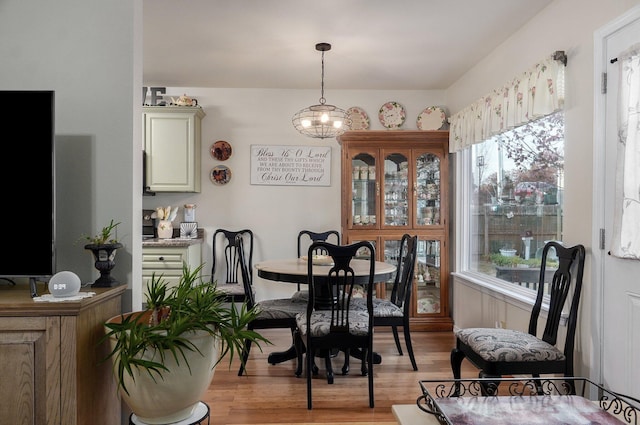 397 Micahs Xing, Reeds Spring, MO 65737 - dining room featuring light wood-style floors, healthy amount of natural light, and a chandelier